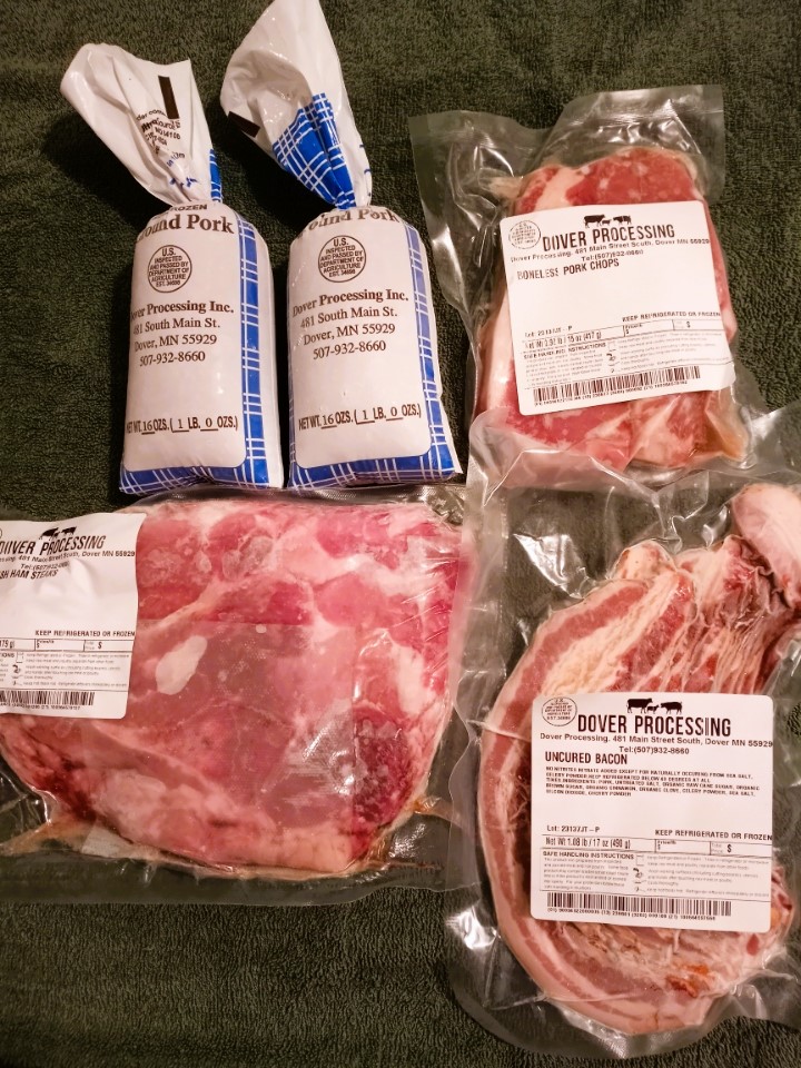 Locally-raised grass-fed beef and heritage pork from Old School Acres in Lake City, MN, featuring steaks, ground beef, and award-winning bacon available at The Greensted in Zumbrota.